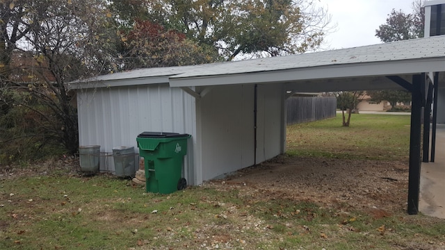 view of outdoor structure featuring a yard and a carport