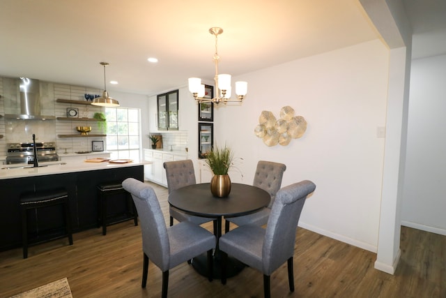 dining room featuring dark hardwood / wood-style flooring and an inviting chandelier