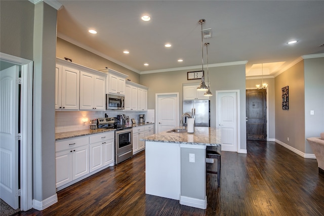 kitchen featuring appliances with stainless steel finishes, white cabinetry, dark hardwood / wood-style floors, and tasteful backsplash