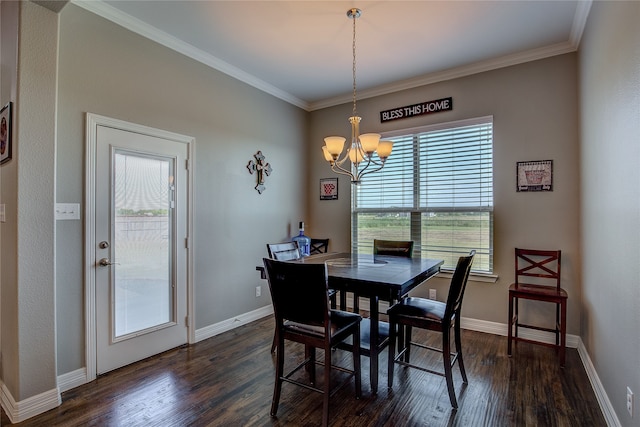 dining area featuring dark wood-type flooring, an inviting chandelier, and crown molding