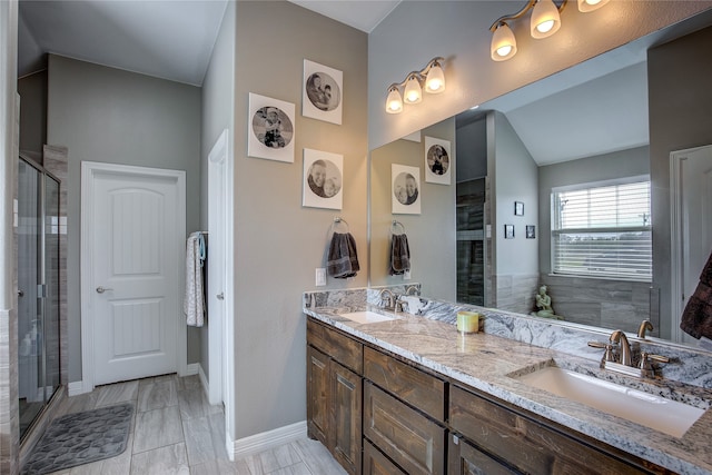 bathroom featuring a shower with shower door, vanity, and tile patterned floors