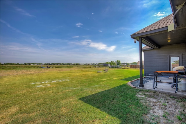 view of yard featuring a patio area and a rural view