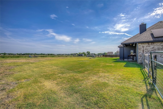 view of yard with a rural view