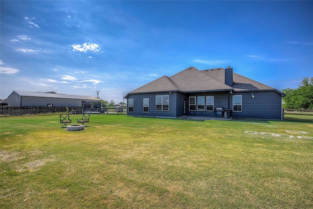 rear view of house featuring a yard