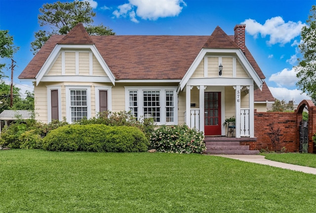 tudor home featuring a front yard