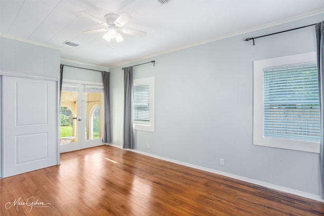 empty room featuring ceiling fan, crown molding, and hardwood / wood-style flooring