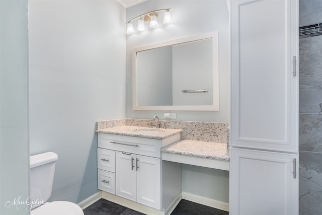 bathroom featuring vanity and toilet