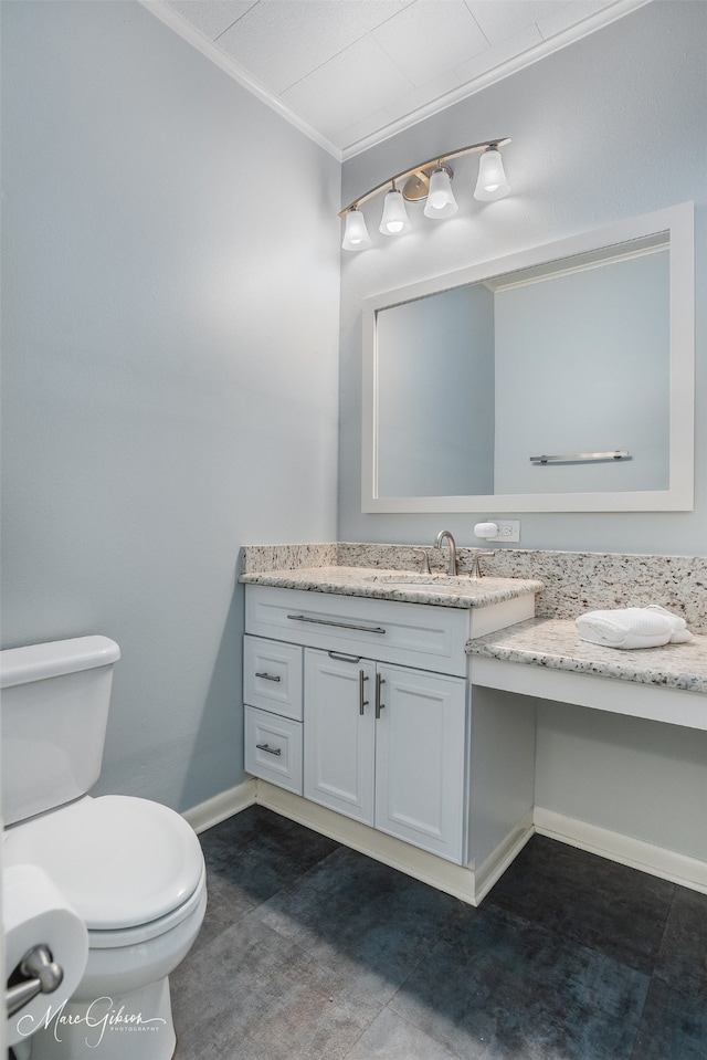 bathroom featuring tile patterned flooring, vanity, toilet, and crown molding