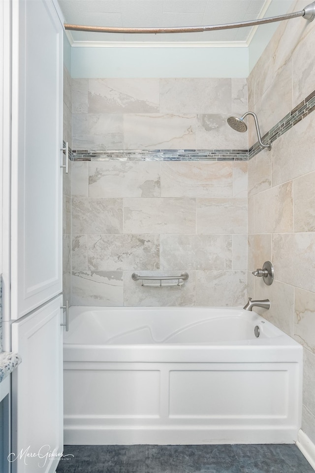 bathroom with tiled shower / bath and ornamental molding