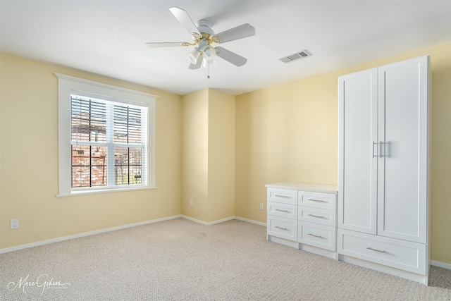 unfurnished bedroom featuring ceiling fan and light colored carpet