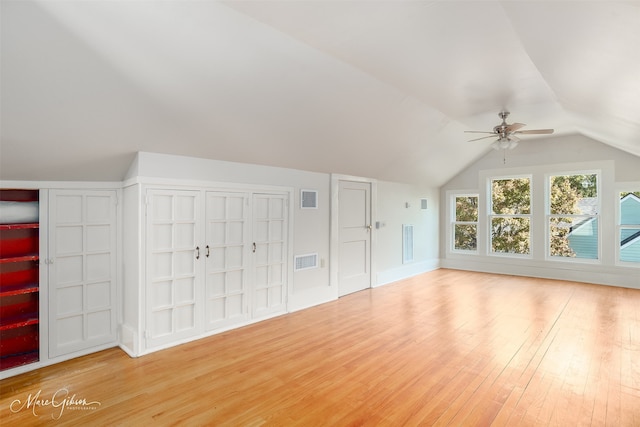 additional living space featuring light wood-type flooring, ceiling fan, and lofted ceiling