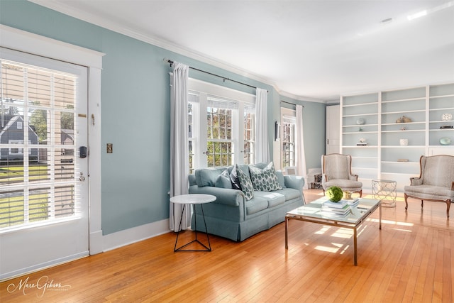 living room with ornamental molding and wood-type flooring