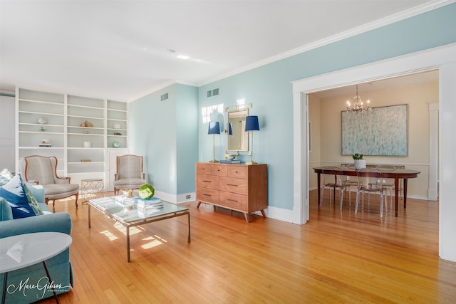 living room featuring a notable chandelier, wood-type flooring, and ornamental molding