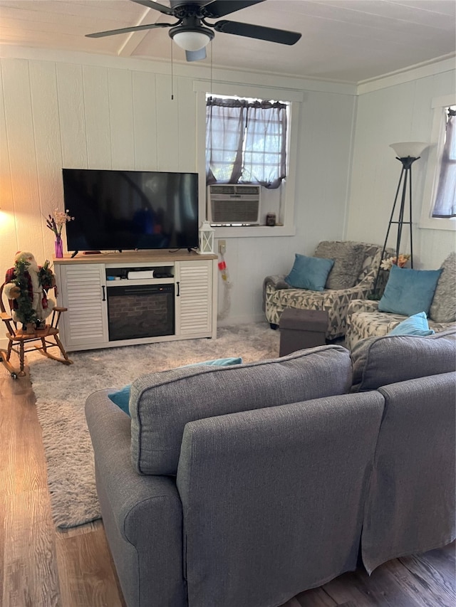 living room with ceiling fan, hardwood / wood-style flooring, crown molding, and cooling unit