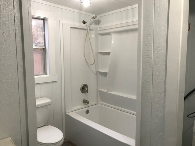 bathroom with shower / washtub combination and toilet