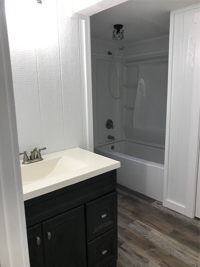 bathroom with shower / washtub combination, vanity, and hardwood / wood-style floors