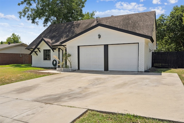 single story home with a garage and a front yard