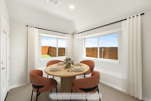 dining room with light tile patterned floors and a wealth of natural light