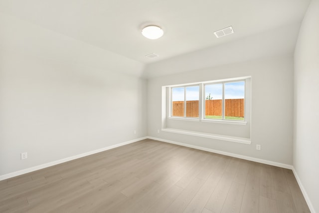 unfurnished room with hardwood / wood-style flooring