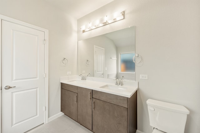 bathroom with tile patterned flooring, vanity, and toilet