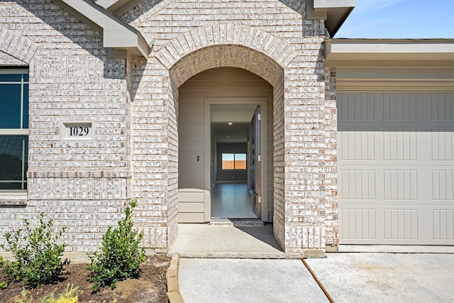 doorway to property with a garage