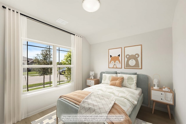 bedroom featuring hardwood / wood-style floors and lofted ceiling