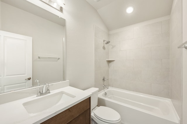 full bathroom with tiled shower / bath combo, toilet, vanity, and vaulted ceiling