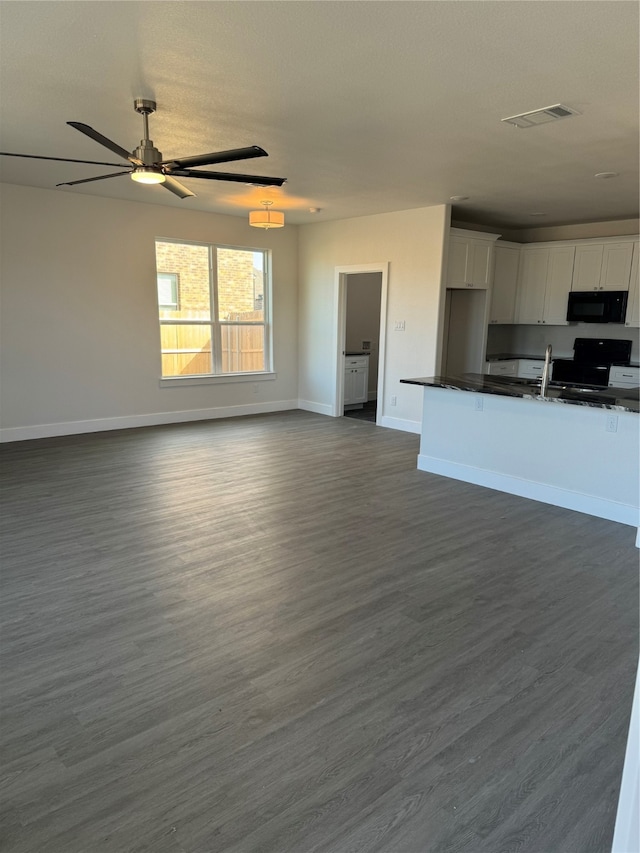 kitchen with ceiling fan, dark hardwood / wood-style floors, range, and white cabinets