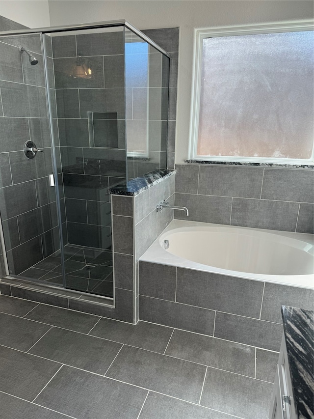 bathroom featuring tile patterned floors, separate shower and tub, and vanity