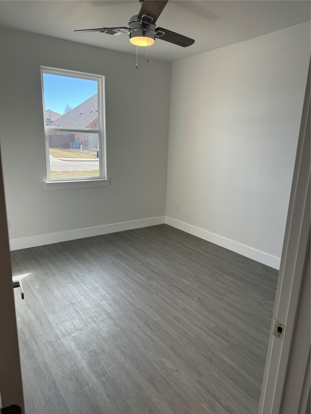 spare room featuring ceiling fan and dark hardwood / wood-style flooring