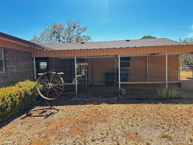 rear view of house featuring a sunroom