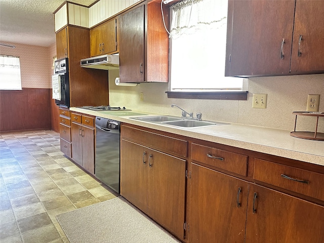 kitchen featuring a wealth of natural light, sink, black appliances, and a textured ceiling