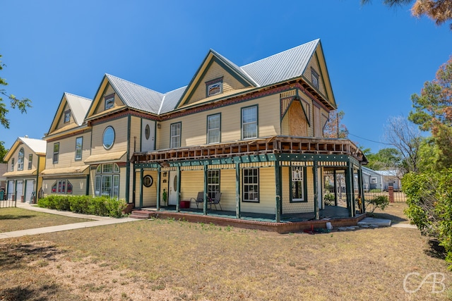 view of front of house with a porch and a front lawn