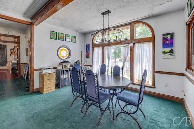 carpeted dining space featuring a notable chandelier and a textured ceiling