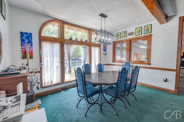 carpeted dining area with a textured ceiling, beam ceiling, and an inviting chandelier