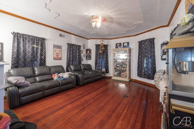 living room featuring hardwood / wood-style flooring, a textured ceiling, and crown molding