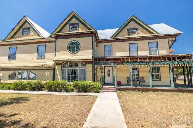 view of front of house with a front lawn and a porch