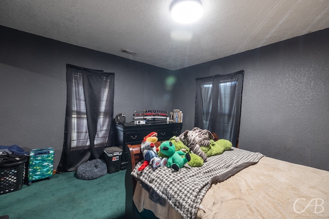 carpeted bedroom with a textured ceiling