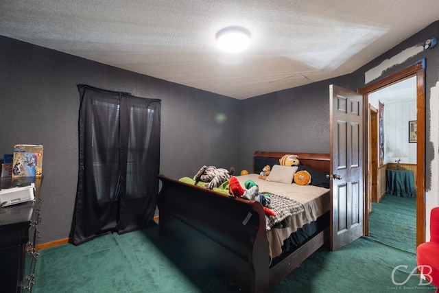 bedroom featuring carpet floors and a textured ceiling