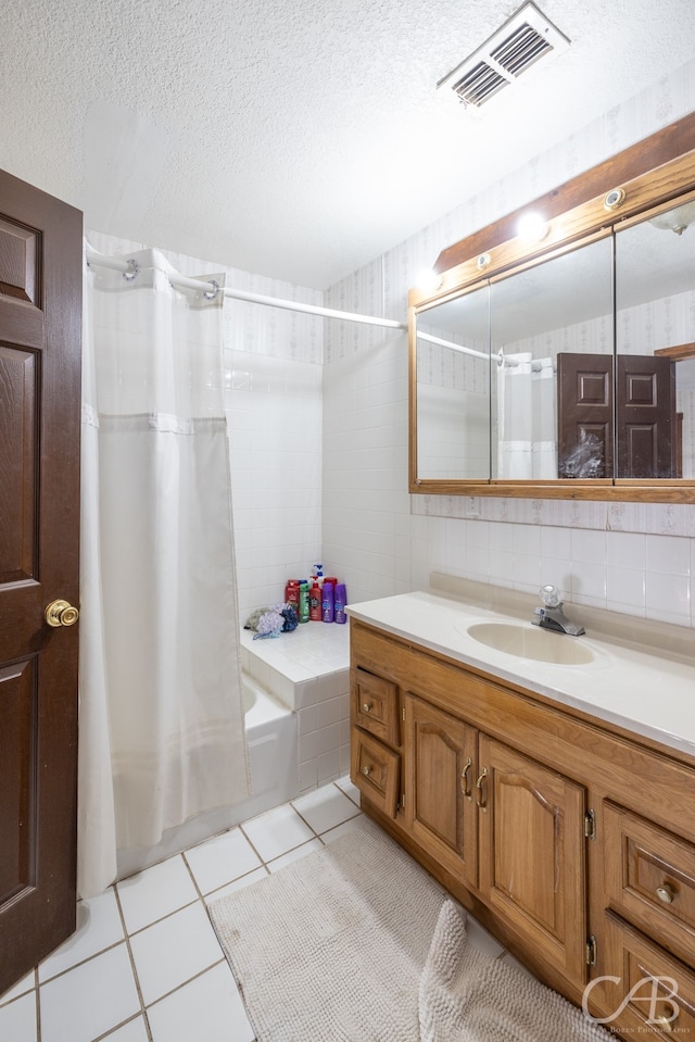 bathroom featuring backsplash, tile patterned flooring, vanity, a textured ceiling, and shower / bathtub combination with curtain