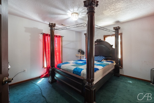 bedroom with carpet floors and a textured ceiling