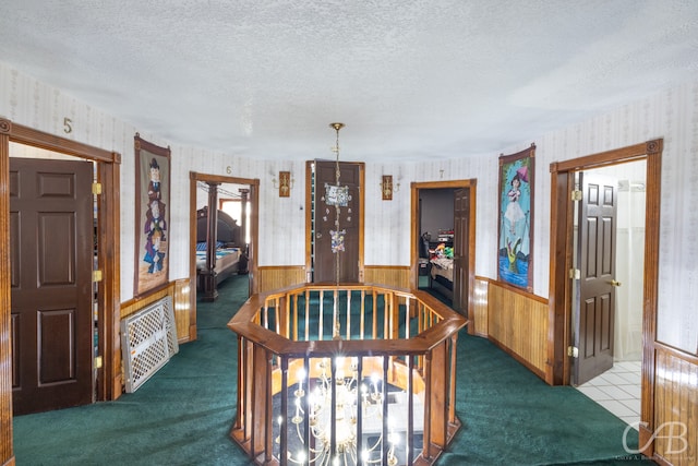 carpeted dining space with a textured ceiling