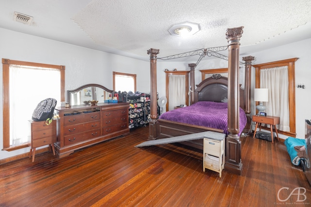 bedroom with hardwood / wood-style flooring and a textured ceiling