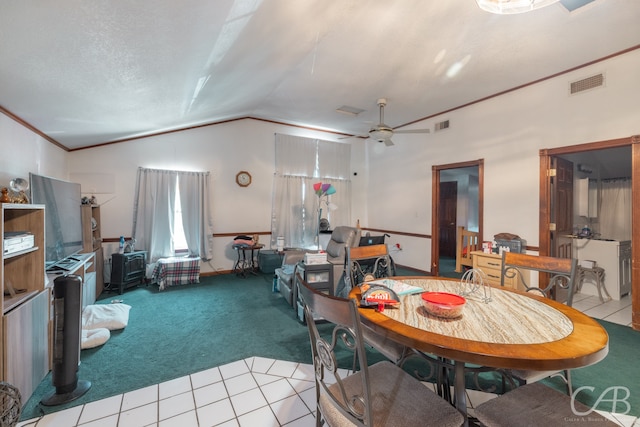 dining room featuring tile patterned flooring, ceiling fan, vaulted ceiling, and crown molding