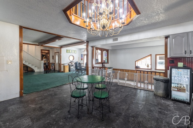 dining room featuring a textured ceiling and an inviting chandelier