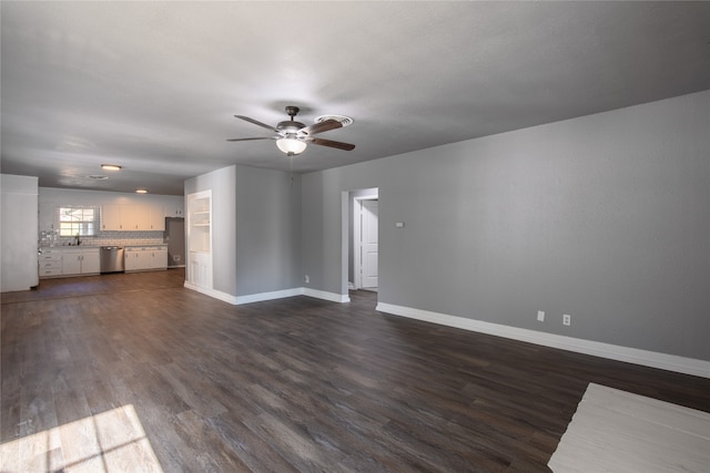 unfurnished living room featuring hardwood / wood-style flooring, sink, and ceiling fan