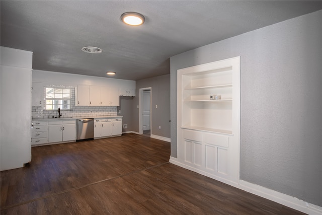 kitchen featuring backsplash, dishwasher, dark wood-type flooring, and white cabinetry