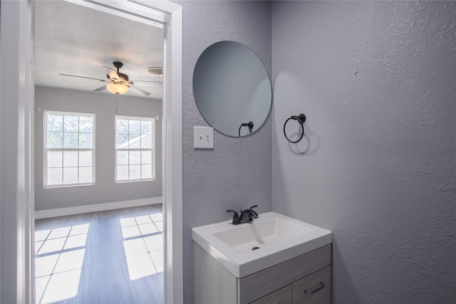 bathroom with ceiling fan and vanity