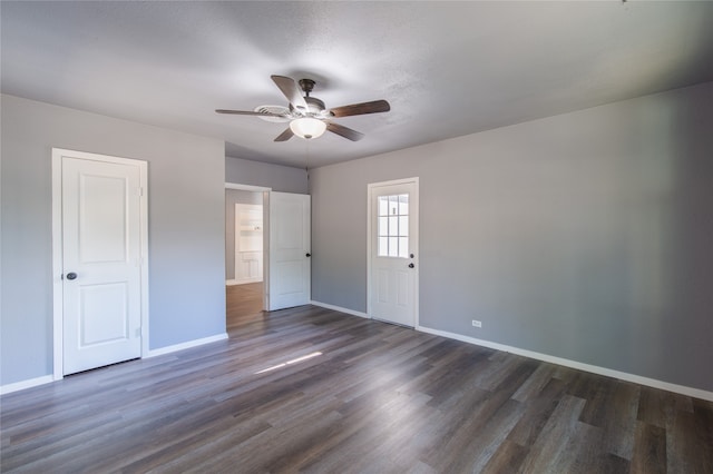 unfurnished bedroom featuring ceiling fan and dark hardwood / wood-style floors