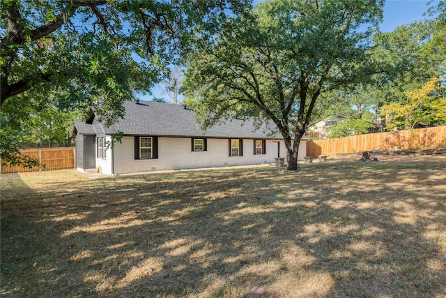 rear view of house with a lawn